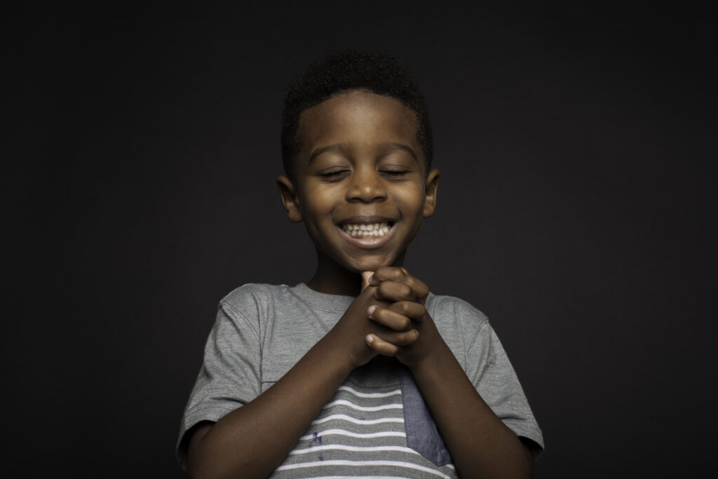 little boy praising Jesus